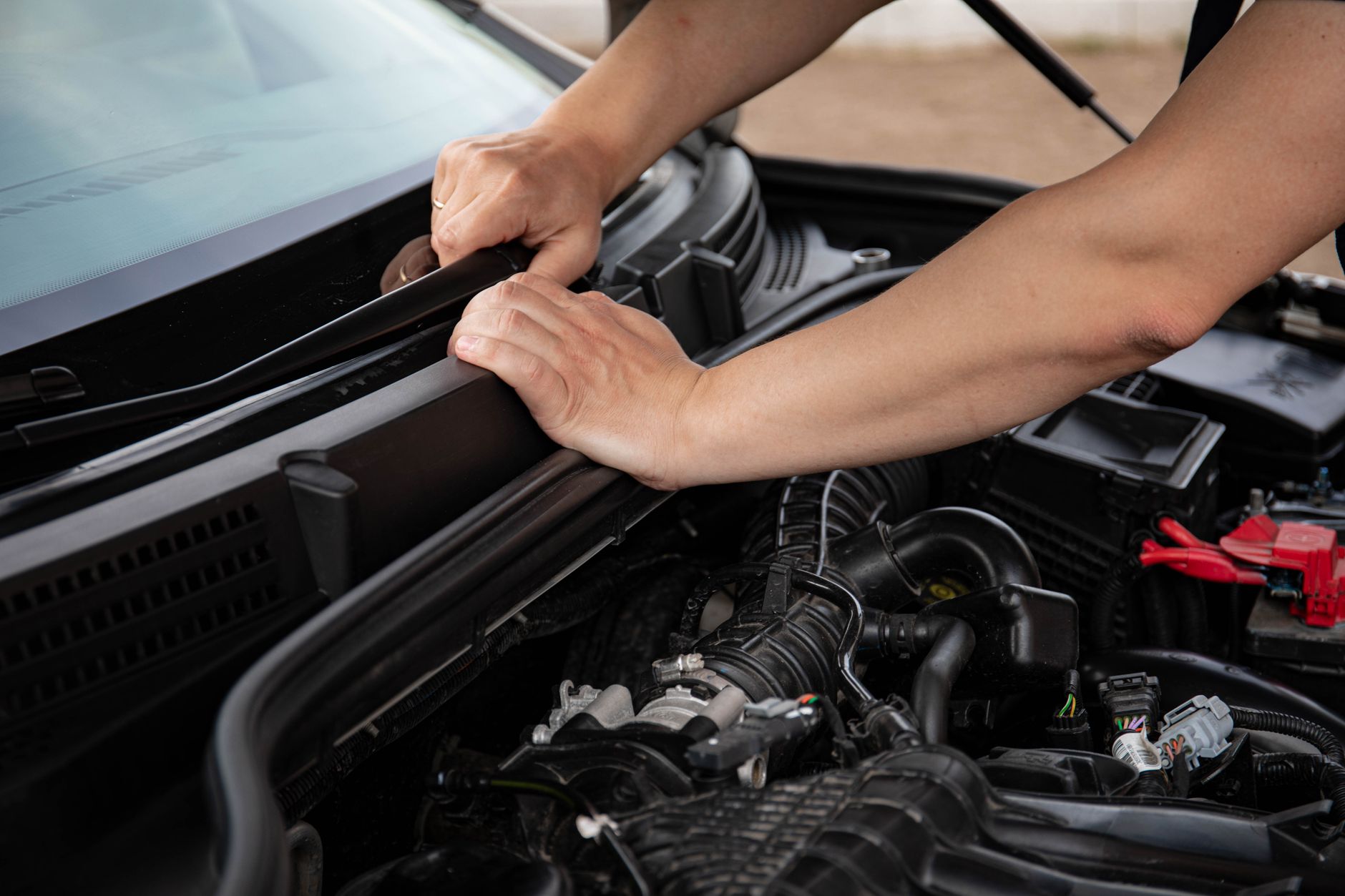 Mechanic checking engine during a full service history verification at an independent garage